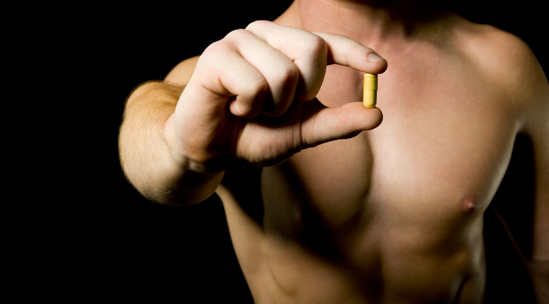 Muscular man holding a SLU-PP-332 pill