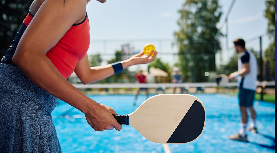 A group of pickleball players playing a round of doubles on the pickleball court