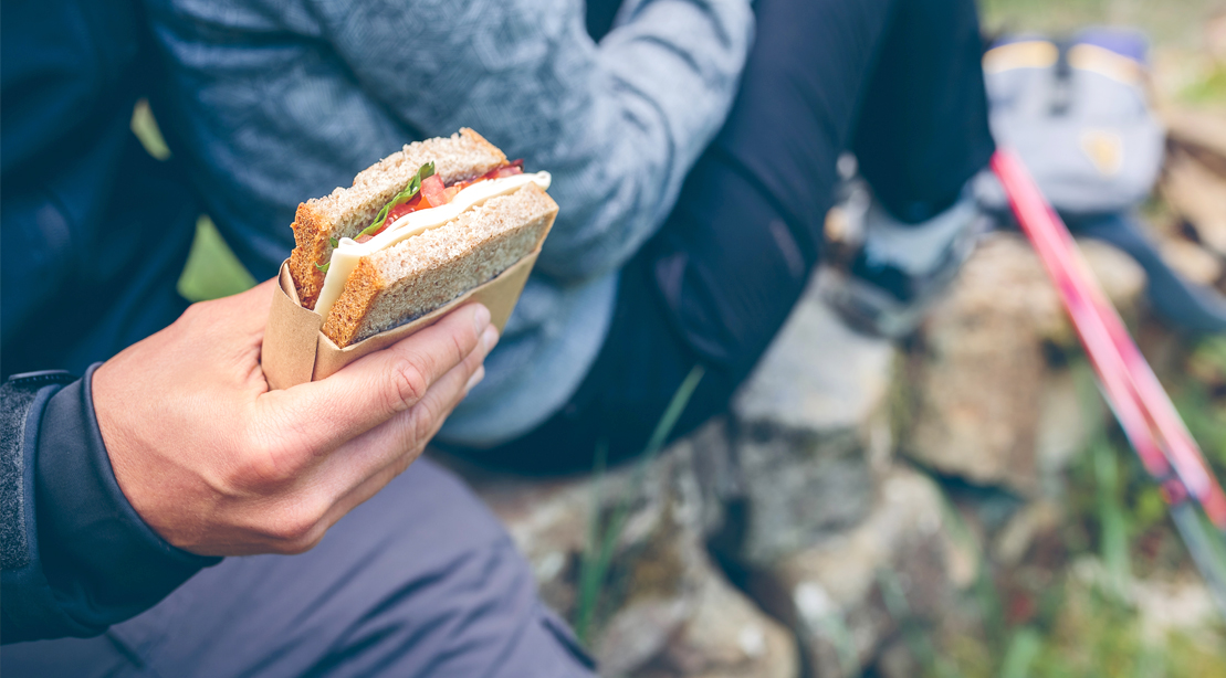 Couple-In-Workout-Gear-Male-Holding-Simple-Sandwich