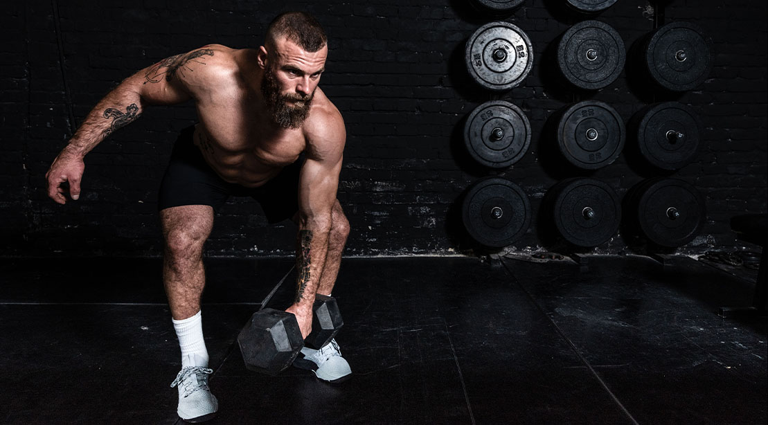 Man Performing a Dumbbell Row for this 15 Minute Tri-set Strength Workout