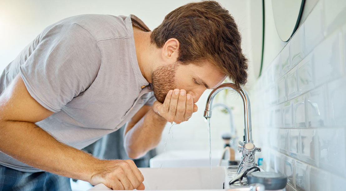 Man rinsing his mouth with a carbohydrate solution